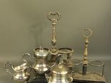 a silver tea set sitting on a table next to a pair of scissors