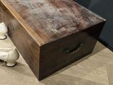 a wooden box with a pair of white shoes next to it
