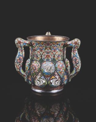 a silver and enamel vase with floral designs on it