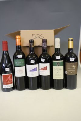 several bottles of wine are lined up in a row on a counter