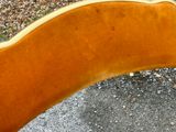 a close up view of a wooden bench on the ground