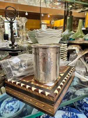 a glass table with a silver vase on top of it
