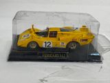 a yellow model of a race car in a clear case