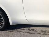 a picture of a white car parked in a parking lot