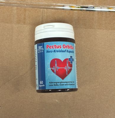 a bottle of pectus orbitine on a cardboard surface