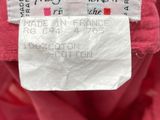 a close up of a label on the back of a pink jacket
