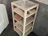 a wooden shelf with towels on it in a bathroom