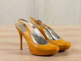 an image of a pair of yellow high heel shoes on a wooden table