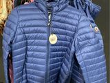 the blue jacket is hanging on the rack in the store