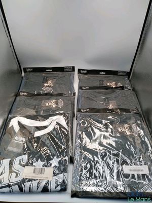 two bags of clothing sitting on top of a table