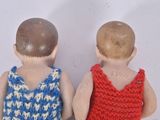 two dolls that are standing next to each other