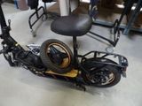 a scooter that is sitting on the floor next to a chair