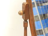 a mirror that is on a stand with a racket in it