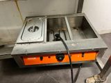 a picture of a kitchen with two pans on the stove