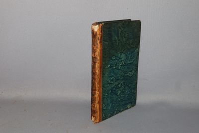 a green book sitting on top of a white table