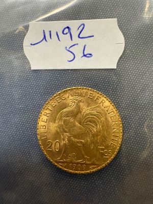 a close up of a gold coin with a label on it