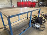 an image of a work table with a lot of tools in the background