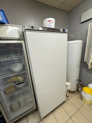 a refrigerator and freezer in a small room