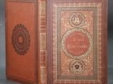 an old book with a brown cover sitting on top of a table