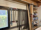 a picture of a workbench in a garage with tools hanging on the wall