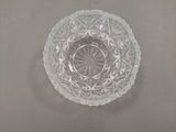 a clear glass bowl on a table with a white background