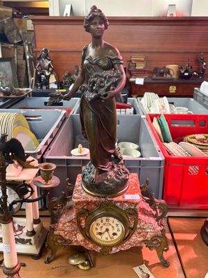 a statue of a woman that is sitting on a table