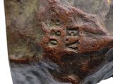 a close up of a statue of a dog with a paw print on it