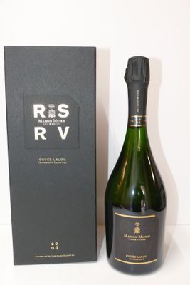 the bottle of wine is next to the box on the table