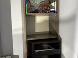 a small cabinet with a tv on top of it