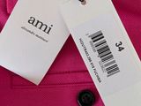 an image of a pink jacket with a tag attached to it