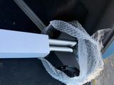 a plastic wrap wrapped around the handle of a black suitcase