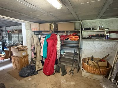 an image of a room with a bunch of clothes on a rack