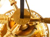 a gold clock that is on a white surface
