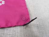 a small pink bag with a flower design on it