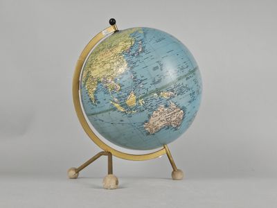 a small blue and gold globe on a stand