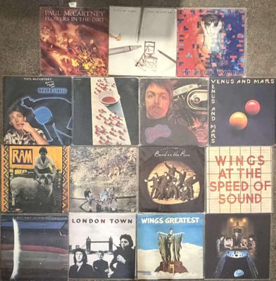 a lot of different album covers on the floor