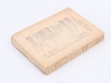 an old book that is sitting on a white surface