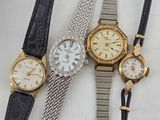 three ladies ' s wrist watches and a ladies ' s watch on a white surface