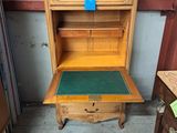 a wooden cabinet with a green mat on top of it
