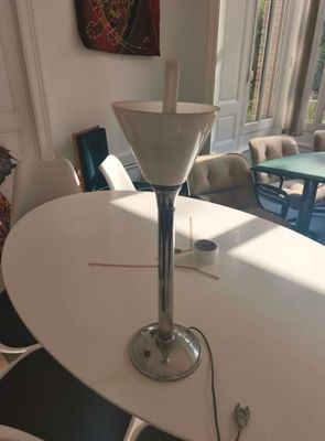 a white table with a glass vase on top of it