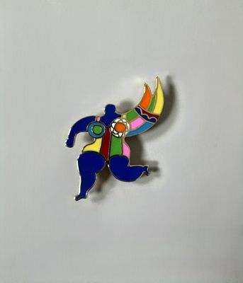 a close up of a pin with a person holding a banana