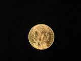 a close up of a gold coin on a black background