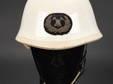 an image of a white helmet with a gold eagle on it