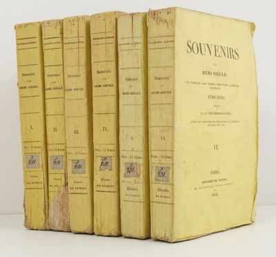 four yellow books sitting on top of each other on a white surface
