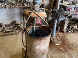 a metal bucket sitting on top of a table in a garage