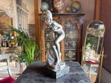 a statue of a woman that is sitting on a table