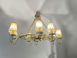 a chandelier with five lamps hanging from the ceiling