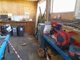 an image of a garage with a lot of clutter and tools