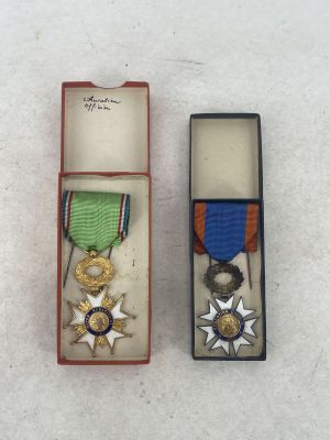 two medals in a box on a white surface