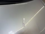 a sticker on the hood of a white car